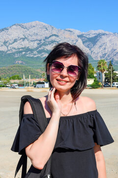 Happy brunette woman tourist exploring new country on a hot sunny day enjoying her summer vacation travel and discovering foreign culture.