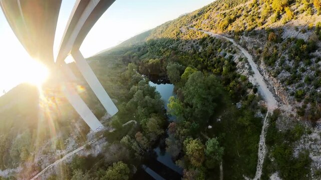 Aerial View of Modern Highway Bridge Over River Valley at Sunset