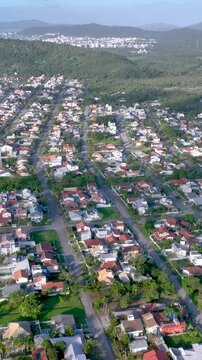 Florian&oacute;polis, Daniela Beach. Aerial View of Tropical Coastline. Establishing Shot. Santa Catarina, Brazil. Vertical video