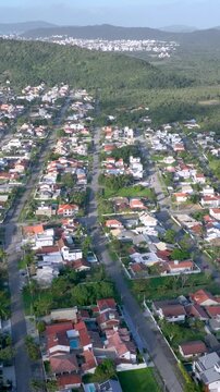 Florian&oacute;polis, Daniela Beach. Aerial View of Tropical Coastline. Establishing Shot. Santa Catarina, Brazil. Vertical video