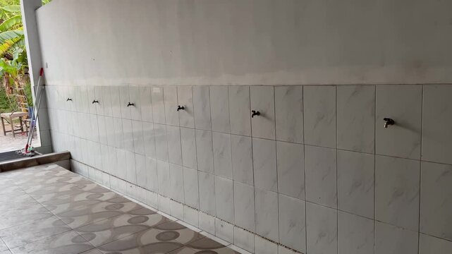 Minimalist Islamic ablution area with water taps in modern mosque