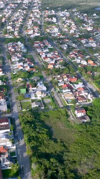 Florian&oacute;polis, Daniela Beach. Aerial View of Tropical Coastline. Establishing Shot. Santa Catarina, Brazil. Vertical video