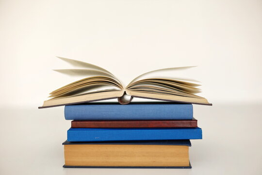 stack of books against the background of library, stack of books in front of library, books on wooden table, education, High quality book photography, Best Book Photo
