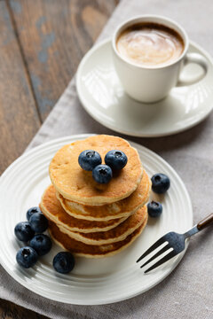 Tasty breakfast pancakes with blueberries, butter and maple syrup