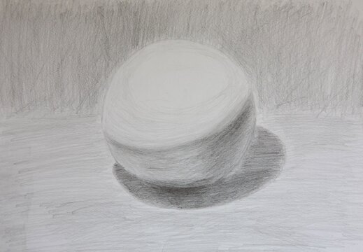 Handmade academic drawing of a ball with a shadow made with graphite pencils on whatman paper