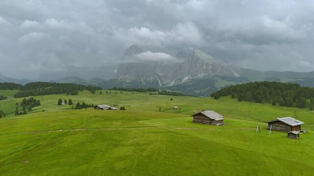 Drone Flight Over Alpe di Siusi Meadows Under Dramatic Summer Sky
