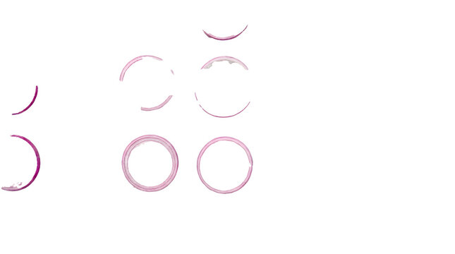 A top down view of multiple red onion rings arranged in a pattern on a white marble surface.