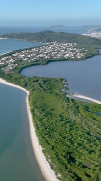 Florian&oacute;polis, Daniela Beach. Aerial View of Tropical Coastline. Establishing Shot. Santa Catarina, Brazil. Vertical video