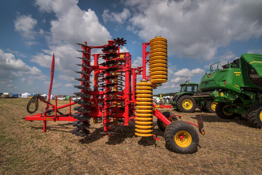 Bilogirya, Khmelnytsky region, UKRAINE - August 19, 2021: Red harrow folded for transportation for cultivating the land at field demonstration