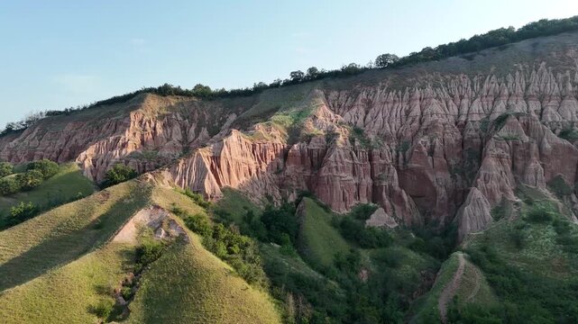 Sunrise Drone Flight Over Rapa Rosie Eroded Hills in Romania
