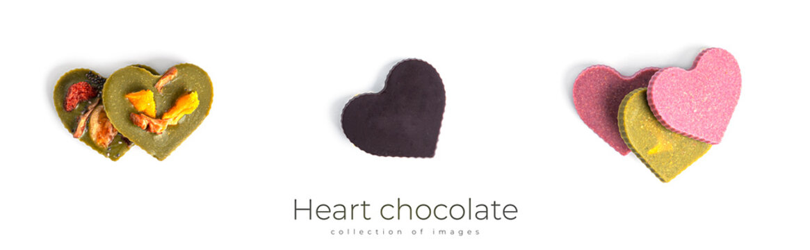 Raw heart shaped chocolate with dried fruits and nuts on a white background.