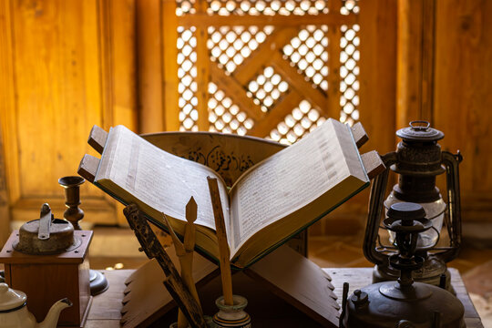 Ancient Open Quran on Wooden Rehal with Antique Lanterns in Historic Marrakech