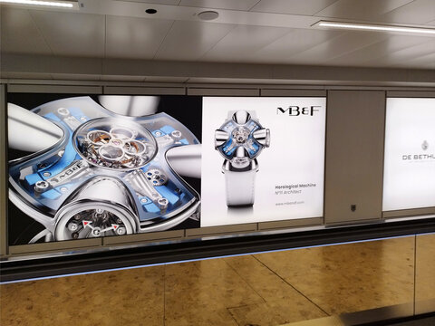 Geneva, Switzerland, Europe - 04.2026 : MB&F (Maximilian B&uuml;sser & Friends) brand of luxury futuristic timepieces,  marketing board at Geneva Airport arrivals