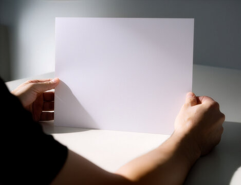 Single white flyer mockup template held by hands in sunlight