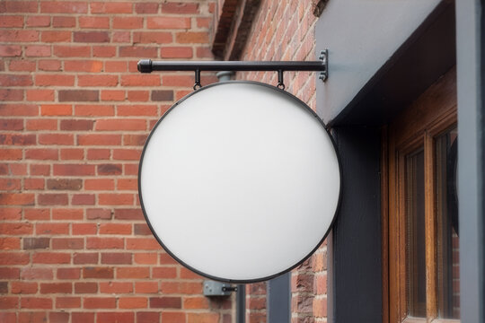 Round white storefront sign mockup template on brick wall