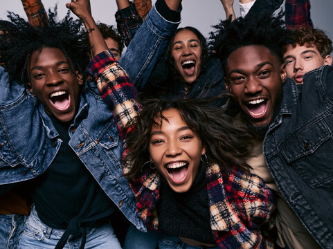 Diverse Group of Young Friends Cheering and Celebrating Together