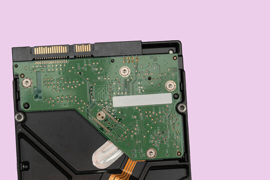 Hard drive circuit board on a plain background with focus on electronic components and connections