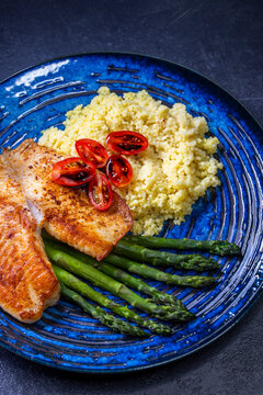 salmon with asparagus and couscous and cherry tomatoes topped with a balsamic vinegar sauce