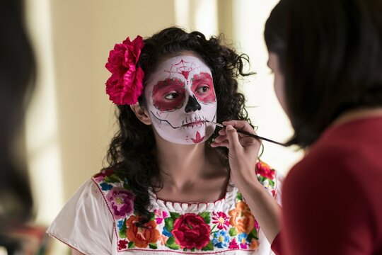 Dia de los Muertos Child Receiving Sugar Skull Face Painting