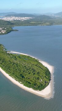 Florian&oacute;polis, Daniela Beach. Aerial View of Tropical Coastline. Establishing Shot. Santa Catarina, Brazil. Vertical video
