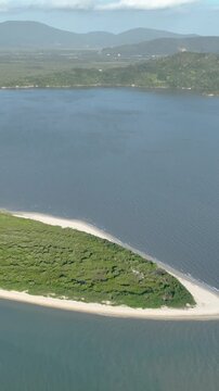 Florian&oacute;polis, Daniela Beach. Aerial View of Tropical Coastline. Establishing Shot. Santa Catarina, Brazil. Vertical video