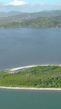 Florian&oacute;polis, Daniela Beach. Aerial View of Tropical Coastline. Establishing Shot. Santa Catarina, Brazil. Vertical video