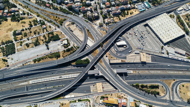 Aerial drone photo of urban multilevel highway junction road using multiple bridges forming a spaggheti road with light traffic