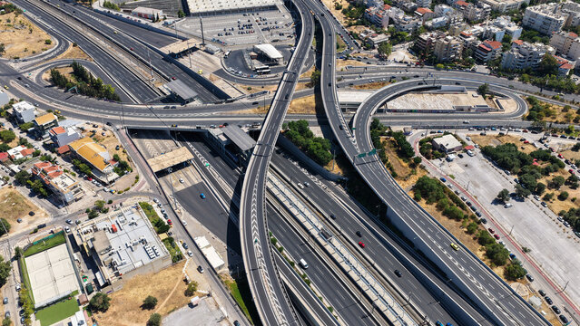 Aerial drone photo of urban multilevel highway junction road using multiple bridges forming a spaggheti road with light traffic