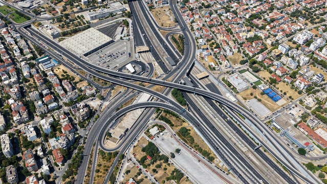 Aerial drone photo of urban multilevel highway junction road using multiple bridges forming a spaggheti road with light traffic