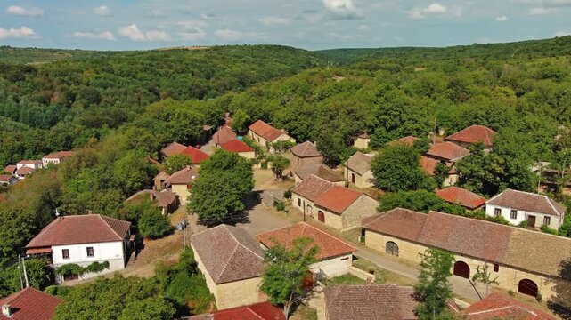Aerial around view of old rustic vintage houses with wine cellars in Rogljevacke pivnice in Negotin region of Serbia, 4k