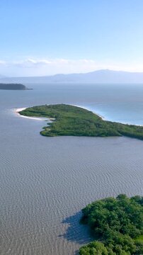 Florian&oacute;polis, Daniela Beach. Aerial View of Tropical Coastline. Establishing Shot. Santa Catarina, Brazil. Vertical video
