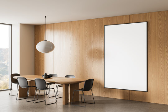 Contemporary wood dining room interior with oval table, pendant light, framed blank artwork, and panoramic window in modern home design. 3D Rendering