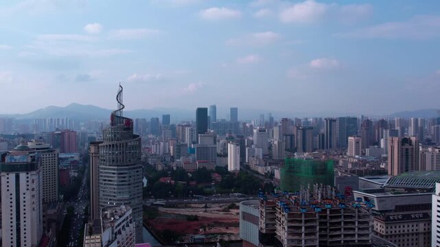 This is an aerial daytime view of a dense modern urban cityscape with skyscrapers and ongoing construction works.