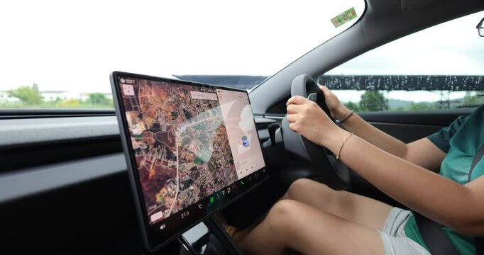 Casual woman drive ev car navigator on screen transport technology