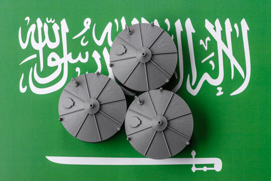 Liquefied gas storage tanks set against the Saudi Arabian flag, concept of supply and distribution