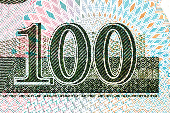 North Korean 100 won banknote featuring ornate traditional geometric patterns and denomination numerals. North Korean money.