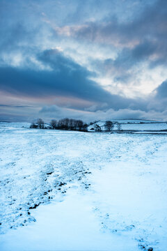 Beautiful Peak District landscape of Winter morning and snowcapped hills in English countryside