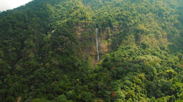 Tropical rainforest landscape with the tall Diamante waterfall in Costa Rica