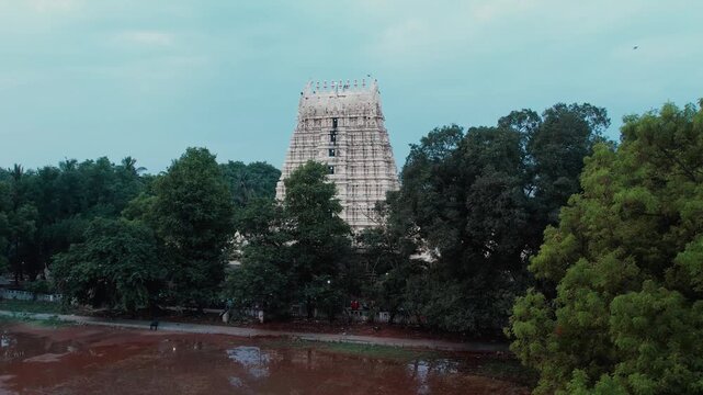 Aerial video of iconic Ramanathaswamy Temple, a magnificent Hindu pilgrimage site, with its towering gopurams and serene atmosphere.network of island and causeways that make up the Pamban Island group