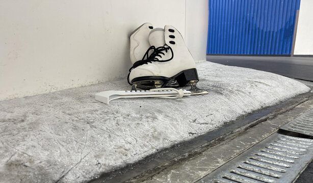 skates with skate blade guards near the ice arena