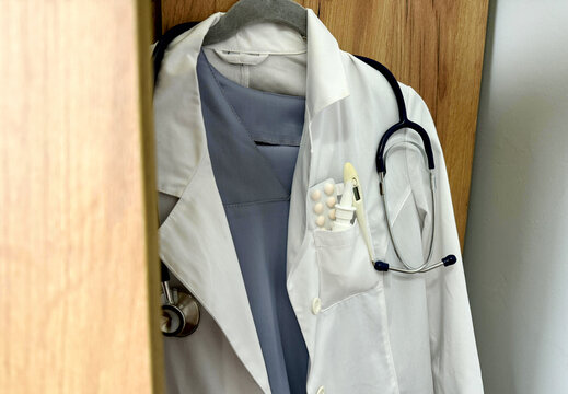 a white coat hanging on a cabinet
