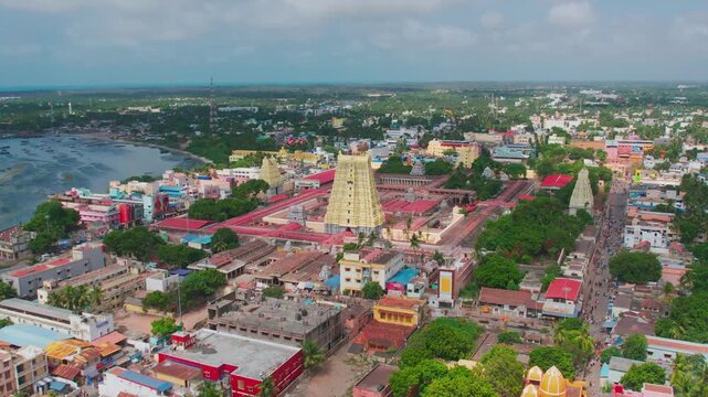 Aerial video of iconic Ramanathaswamy Temple, a magnificent Hindu pilgrimage site, with its towering gopurams and serene atmosphere.network of island and causeways that make up the Pamban Island group