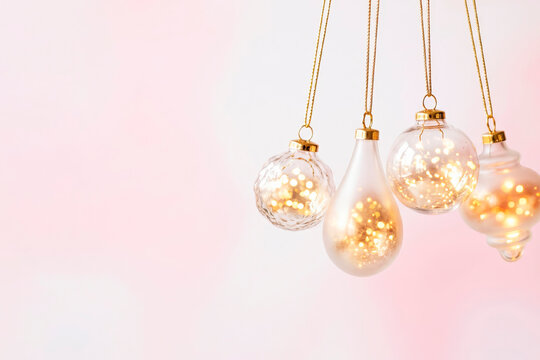 Christmas background with golden glass ornaments on a pink background