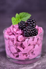 Summer blackberry sorbet with fresh berries on a dark background. Close-up.  © Olivka888