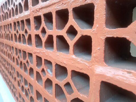 Terracotta breeze block wall texture, geometric clay ventilation brick pattern background