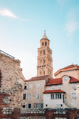 Fototapeta premium Cathedral of St. Duje bell tower in Split city, rising above traditional red tiled rooftops and ancient walls. Croatia