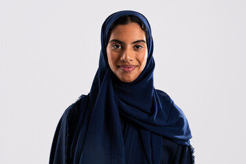 Naklejka premium Studio portrait of smiling muslim woman wearing blue hijab