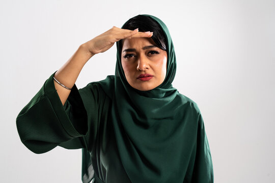 Muslim woman scouting and searching with hand on forehead