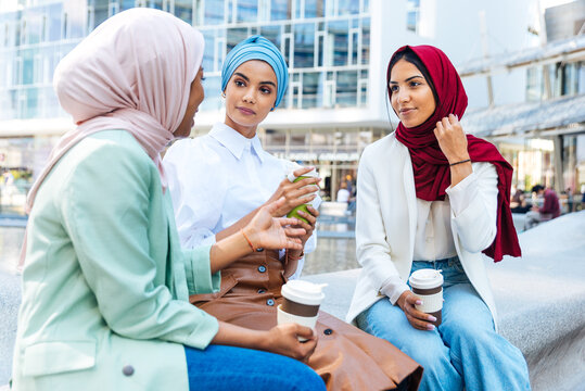 Beautiful muslim girl wearing hijab bonding outdoors