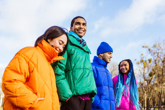 Multiracial group of young friends meeting outdoors in winter